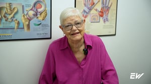 A woman discussing her positive experience receiving physical therapy at EW Motion Therapy.