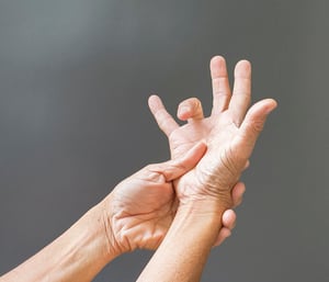 Hands-on physical therapy technique for trigger finger, including finger and wrist stretching to relieve tendon inflammation and restore hand function.