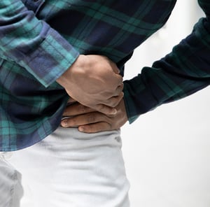 Person experiencing hip discomfort.