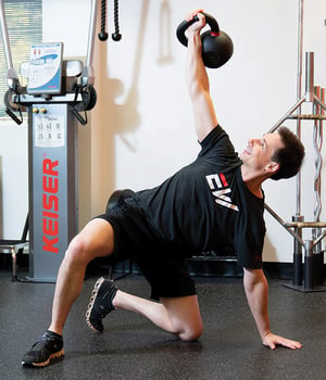 Woman performing lateral band walk exercise during personal training session at EW Motion Therapy.