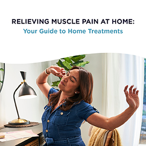 Woman in a denim outfit stretching her neck and shoulders at home, representing EW Motion Therapy's guide to relieving muscle pain at home with dry needling home treatments