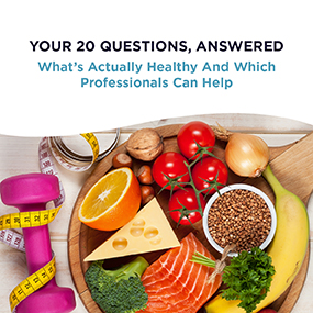 Colorful spread of healthy whole foods including salmon, vegetables, fruit, and a water bottle beside pink dumbbells, representing EW Motion Therapy's nutrition guide on what's actually healthy and which professionals can help