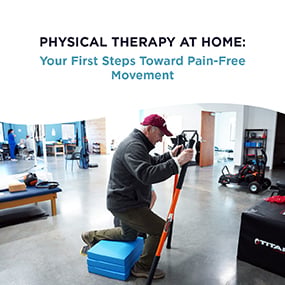 Man in a cap performing a supported squat exercise in a physical therapy gym, representing EW Motion Therapy's home physical therapy guide on first steps toward pain-free movement
