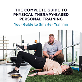 Trainer supervising a woman performing a glute bridge on a gym floor, representing EW Motion Therapy's complete guide to physical therapy-based personal training and smarter training strategies